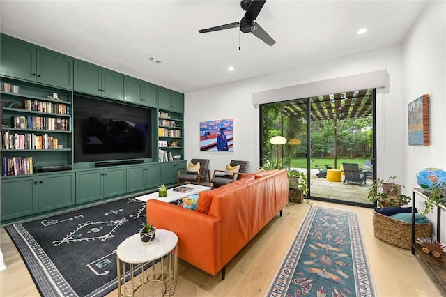 living room with recessed lighting, light wood finished floors, ceiling fan, and built in features