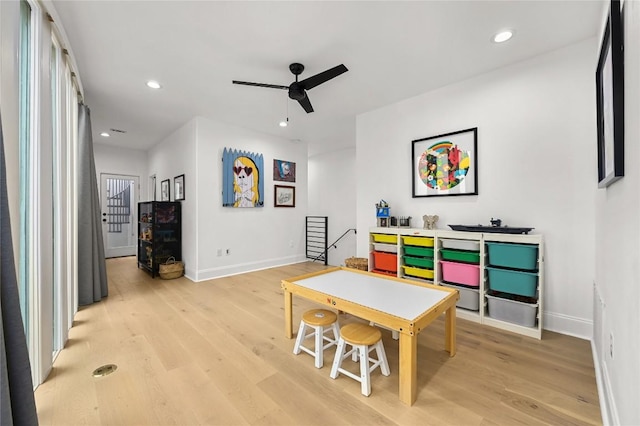 rec room with ceiling fan, baseboards, and light wood-type flooring