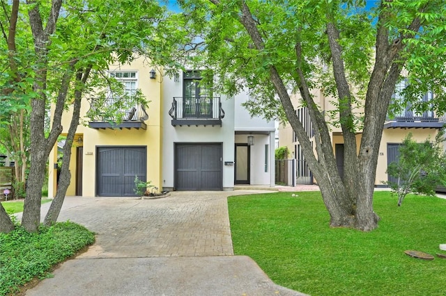 705 W Johanna St Unit B, Austin, TX 78704 - view of property featuring decorative driveway, a balcony, stucco siding, and an attached garage