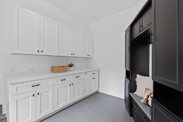 interior space featuring baseboards and light tile patterned floors