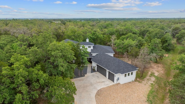 birds eye view of property with a view of trees
