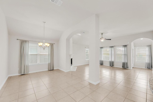 unfurnished room featuring arched walkways, ceiling fan with notable chandelier, light tile patterned floors, lofted ceiling, and visible vents