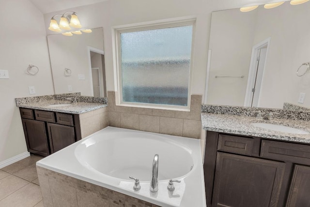 bathroom with a sink, a bath, and a healthy amount of sunlight