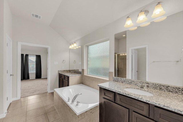bathroom featuring a sink, lofted ceiling, visible vents, a bath, and a stall shower