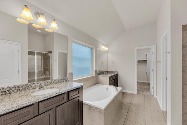 full bathroom featuring tile patterned flooring, a stall shower, two vanities, a sink, and lofted ceiling