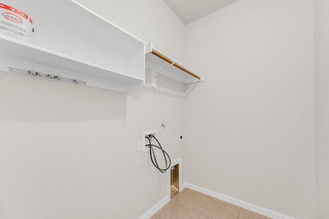 washroom featuring washer hookup, laundry area, electric dryer hookup, baseboards, and light tile patterned flooring