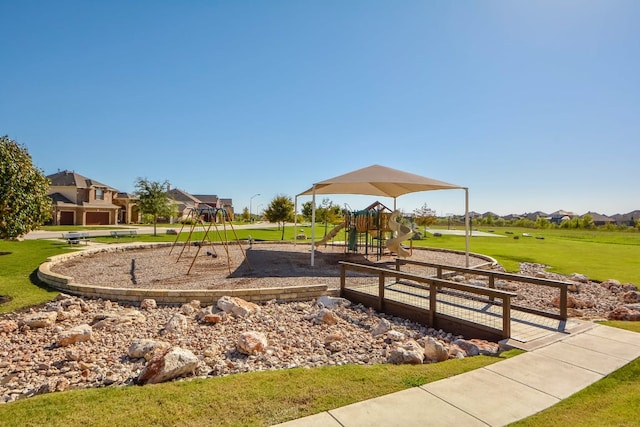 community jungle gym with a yard and a residential view