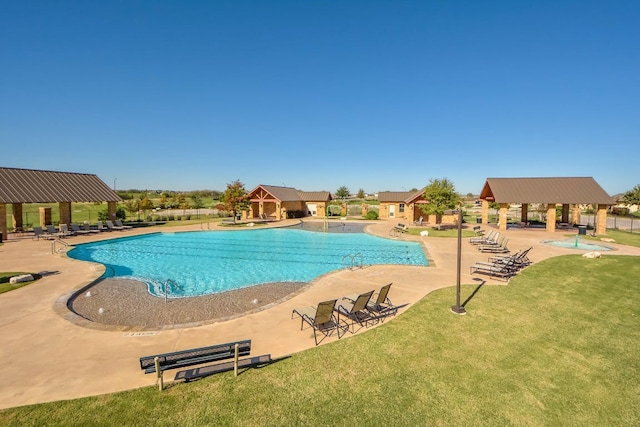 pool featuring a patio, fence, a yard, and a gazebo