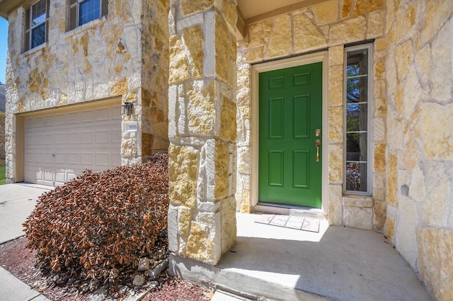 18816 Sandy Shore Dr, Pflugerville, TX 78660 - entrance to property featuring stone siding and a garage