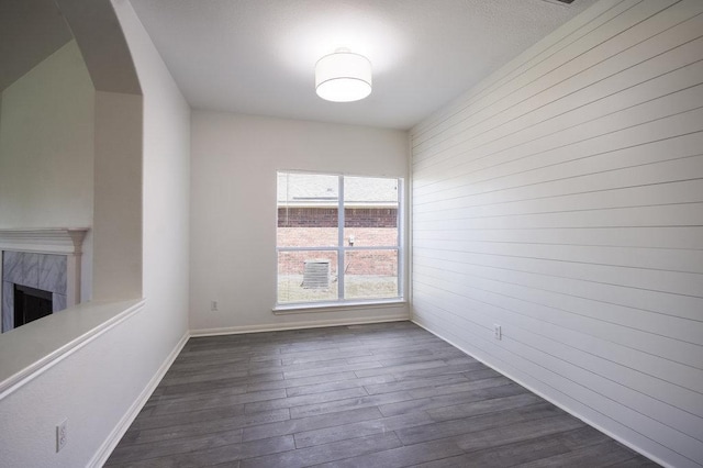18816 Sandy Shore Dr, Pflugerville, TX 78660 - interior space featuring baseboards, arched walkways, dark wood-type flooring, and a premium fireplace
