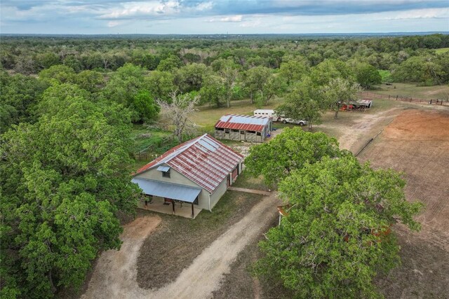 drone / aerial view featuring a forest view