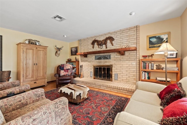 991 Fm 20, Cedar Creek, TX 78612 - living room featuring wood finished floors, a fireplace, and recessed lighting