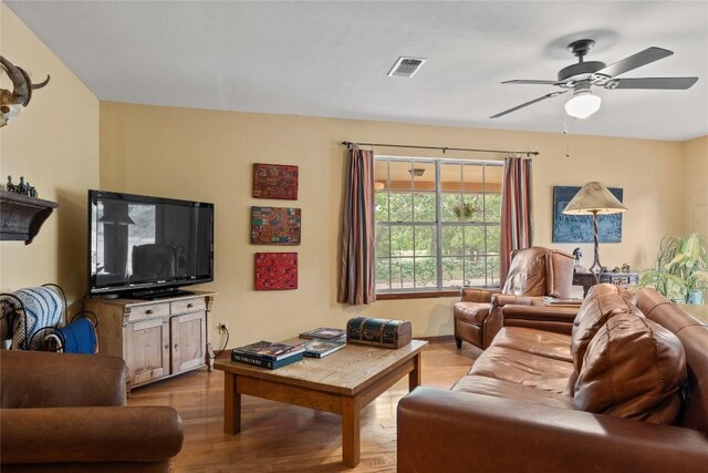 living area featuring ceiling fan, wood finished floors, and visible vents