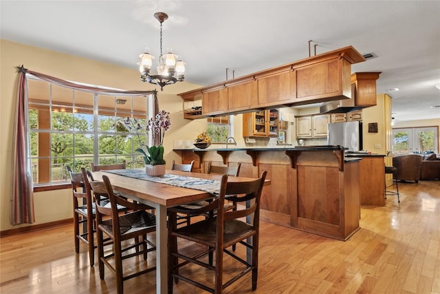 991 Fm 20, Cedar Creek, TX 78612 - dining area featuring light wood finished floors and a chandelier