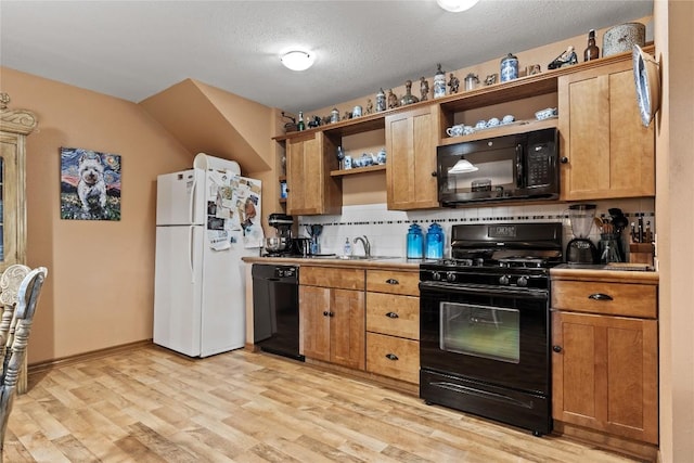 991 Fm 20, Cedar Creek, TX 78612 - kitchen with black appliances, open shelves, light wood-style flooring, decorative backsplash, and a textured ceiling