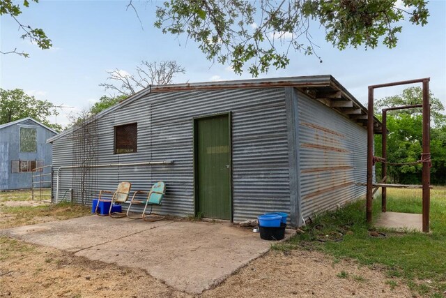 exterior space with a patio and an outbuilding