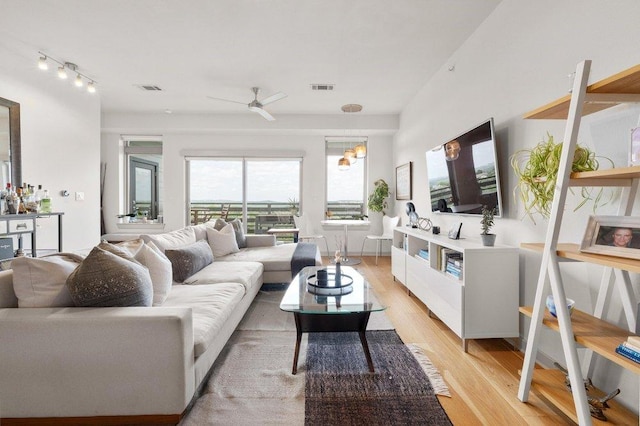 living area featuring ceiling fan, visible vents, and light wood-style flooring
