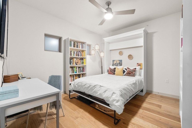 bedroom with ceiling fan and light wood-style flooring