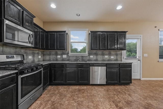349 Eagle Brook Ln, Buda, TX 78610 - kitchen featuring stainless steel appliances, dark cabinetry, a sink, healthy amount of natural light, and recessed lighting