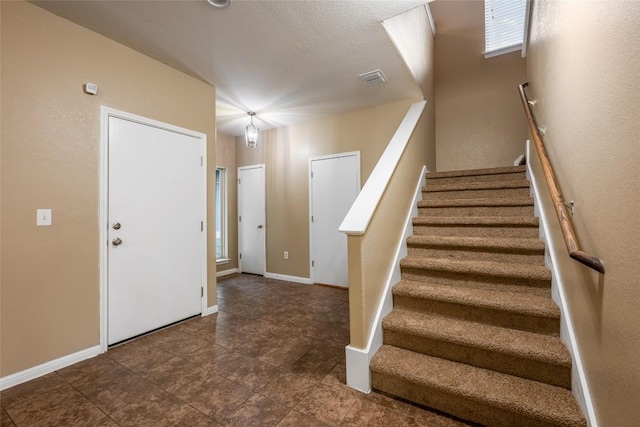 349 Eagle Brook Ln, Buda, TX 78610 - stairs with tile patterned floors and baseboards