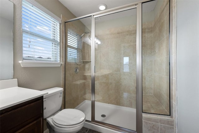 349 Eagle Brook Ln, Buda, TX 78610 - bathroom featuring vanity, toilet, and a stall shower