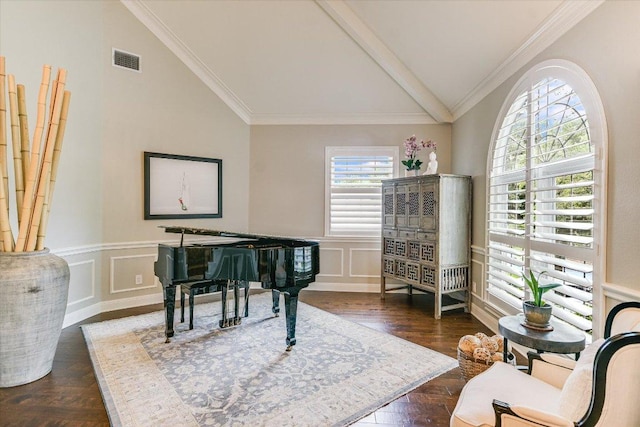living area featuring lofted ceiling with beams, wainscoting, a decorative wall, visible vents, and ornamental molding