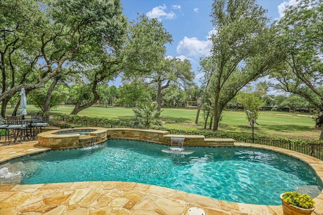 view of pool with a pool with connected hot tub, a patio, and a yard
