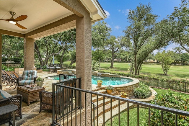 view of patio featuring fence, an in ground hot tub, a fenced in pool, and ceiling fan
