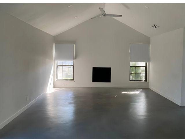 4307 Glenover, San Antonio, TX 78217 - unfurnished living room featuring vaulted ceiling, ceiling fan, baseboards, and plenty of natural light