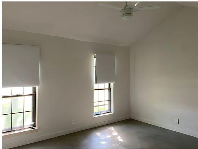 4307 Glenover, San Antonio, TX 78217 - unfurnished room with vaulted ceiling, ceiling fan, baseboards, and concrete floors