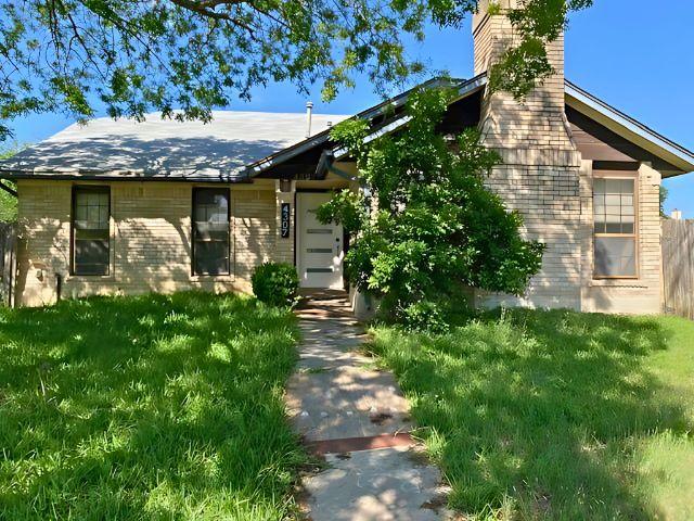 4307 Glenover, San Antonio, TX 78217 - view of front facade featuring a front lawn, brick siding, and a chimney