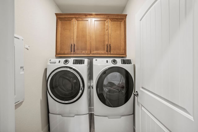 711 Livewater Ln, Georgetown, TX 78633 - laundry room featuring separate washer and dryer and cabinet space