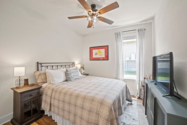 711 Livewater Ln, Georgetown, TX 78633 - bedroom featuring wood finished floors, a ceiling fan, and baseboards
