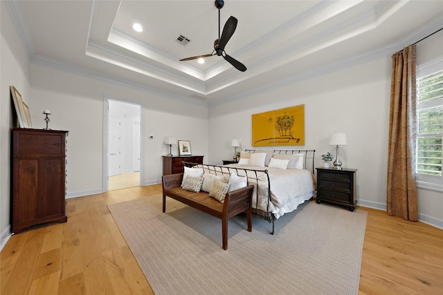 7921 W Rim Dr, Austin, TX 78731 - bedroom with a tray ceiling, crown molding, light wood-style floors, recessed lighting, and a ceiling fan