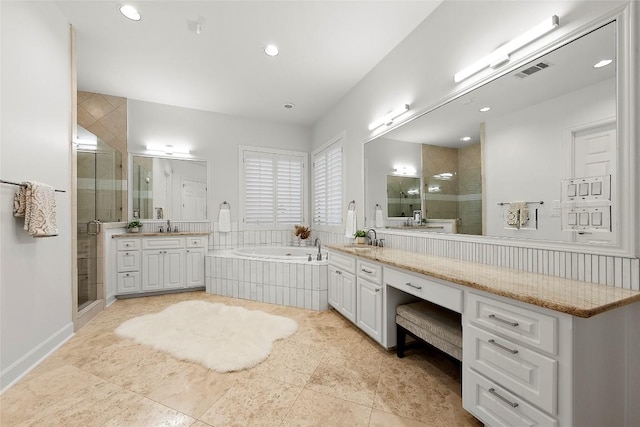 7921 W Rim Dr, Austin, TX 78731 - bathroom featuring a shower stall, two vanities, a garden tub, and recessed lighting