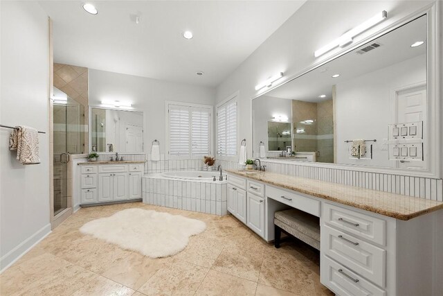 7921 W Rim Dr, Austin, TX 78731 - bathroom with a shower stall, two vanities, a garden tub, and recessed lighting