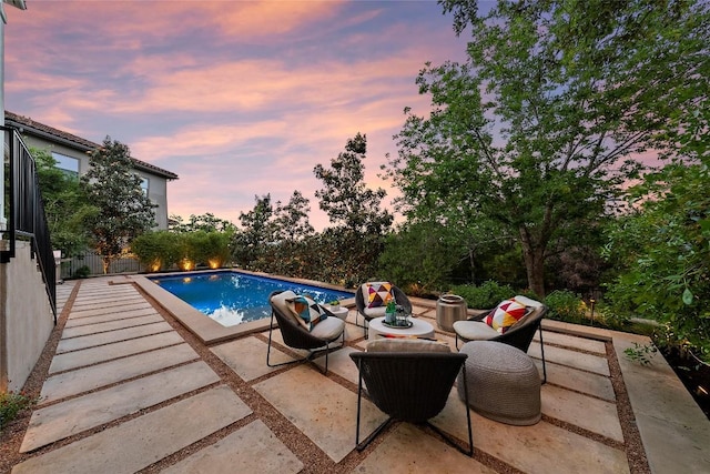 7921 W Rim Dr, Austin, TX 78731 - pool at dusk featuring a patio area