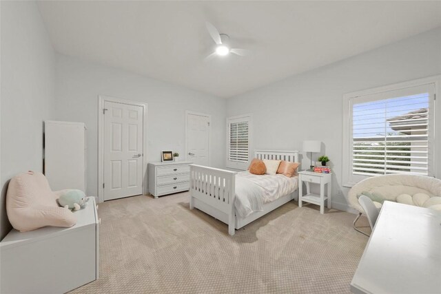 7921 W Rim Dr, Austin, TX 78731 - bedroom with light colored carpet and a ceiling fan