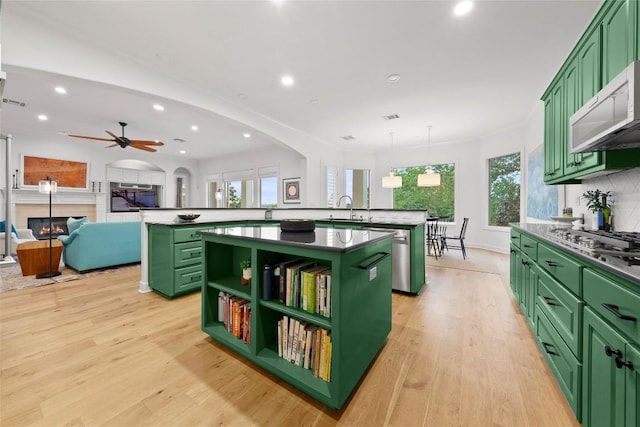 7921 W Rim Dr, Austin, TX 78731 - kitchen featuring green cabinetry, an island with sink, a peninsula, and recessed lighting