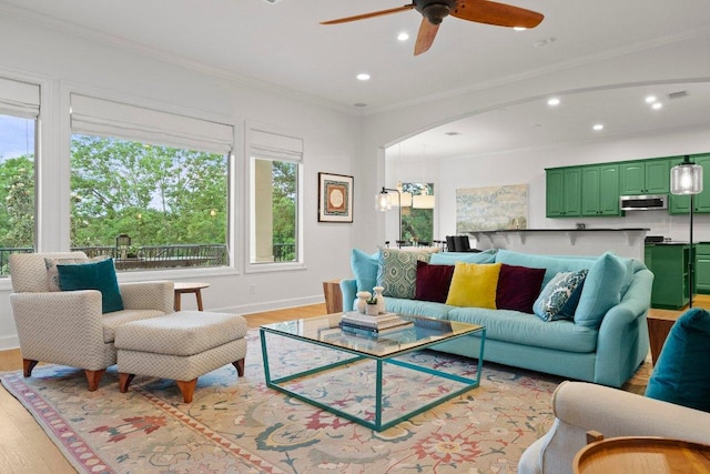 7921 W Rim Dr, Austin, TX 78731 - living area with recessed lighting, light wood finished floors, ceiling fan, ornamental molding, and arched walkways