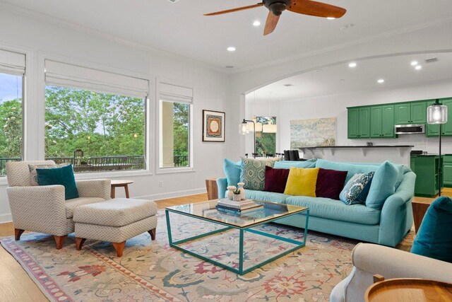 7921 W Rim Dr, Austin, TX 78731 - living area with recessed lighting, light wood-style floors, a ceiling fan, crown molding, and arched walkways