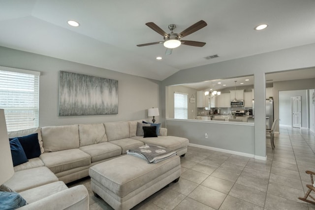 living area with light tile patterned floors, ceiling fan with notable chandelier, recessed lighting, and visible vents