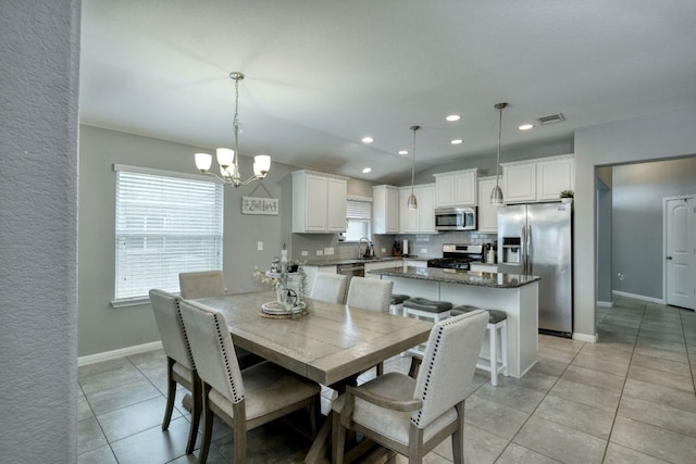 dining space with an inviting chandelier, recessed lighting, baseboards, light tile patterned floors, and visible vents