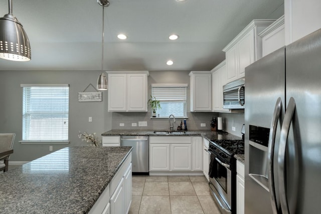 kitchen with a sink, white cabinetry, tasteful backsplash, and stainless steel appliances