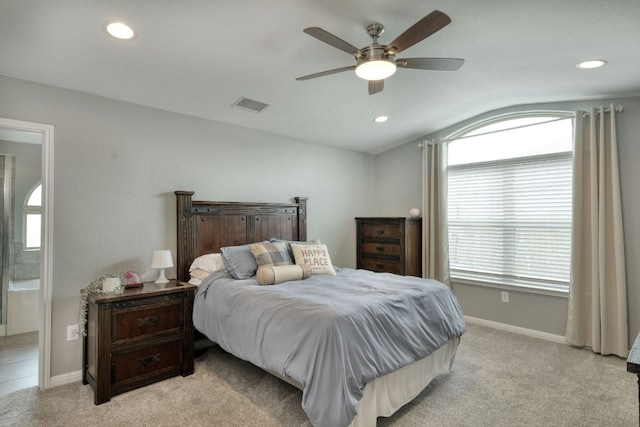 bedroom with visible vents, baseboards, lofted ceiling, and multiple windows