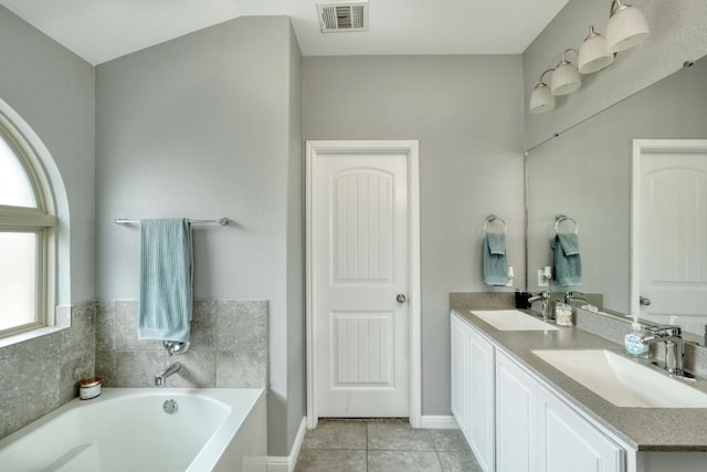 bathroom with tile patterned floors, visible vents, a sink, and a bath