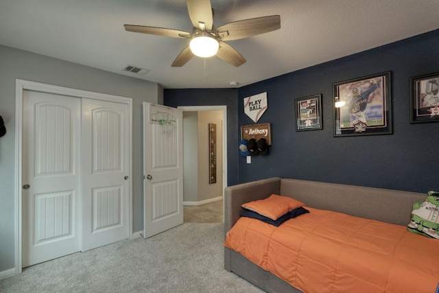 carpeted bedroom featuring a closet, a ceiling fan, baseboards, and visible vents