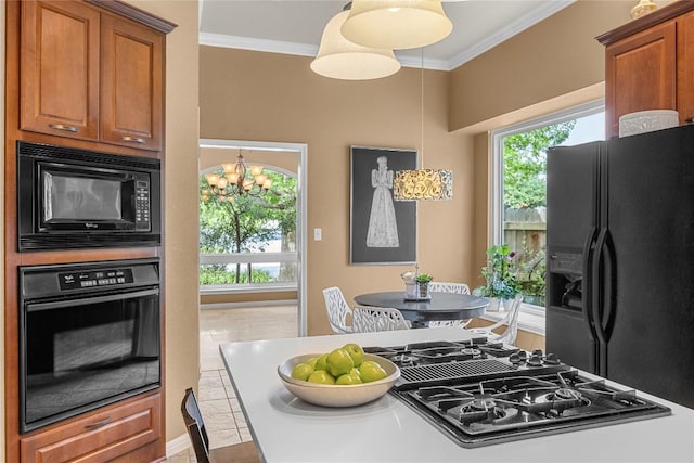 1725 Buttercup Creek Blvd, Cedar Park, TX 78613 - kitchen with black appliances, ornamental molding, brown cabinets, and a chandelier