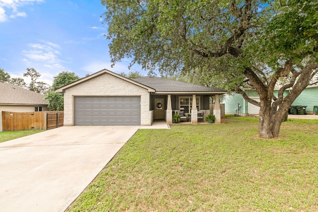 ranch-style house with fence, a garage, a front yard, covered porch, and driveway