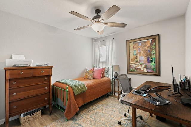 bedroom featuring light wood-style floors and a ceiling fan